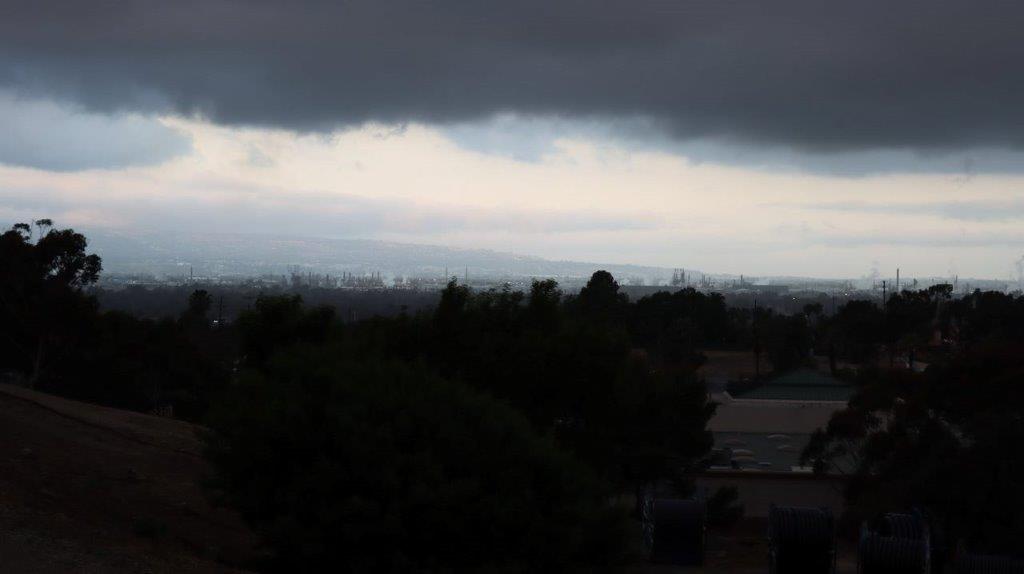 A dark clouds over a city

Description automatically generated