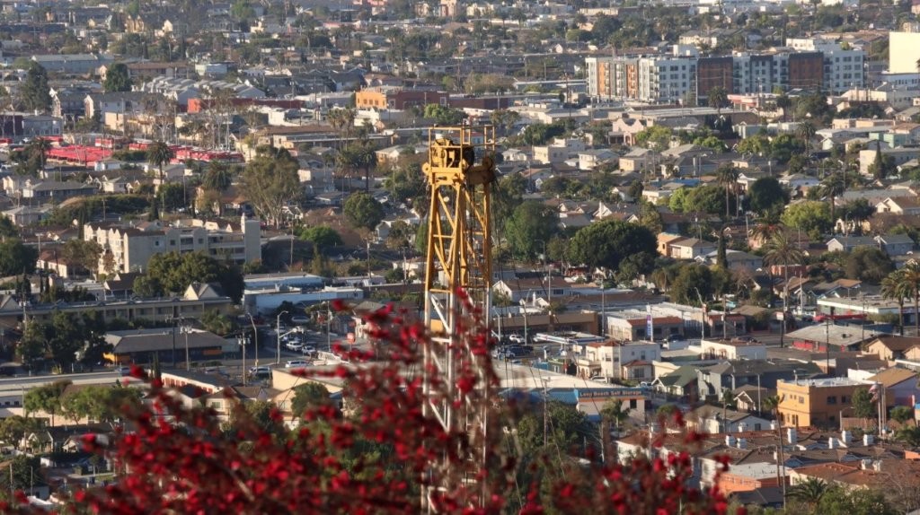 A tall yellow tower in a city

AI-generated content may be incorrect.