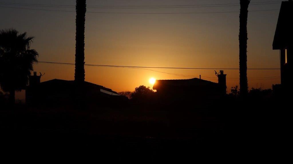 A sunset over a house

Description automatically generated with medium confidence