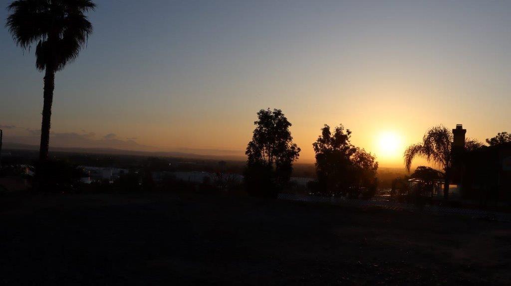 A sunset over a field

Description automatically generated