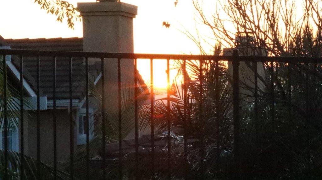 A sunset behind a fence

Description automatically generated