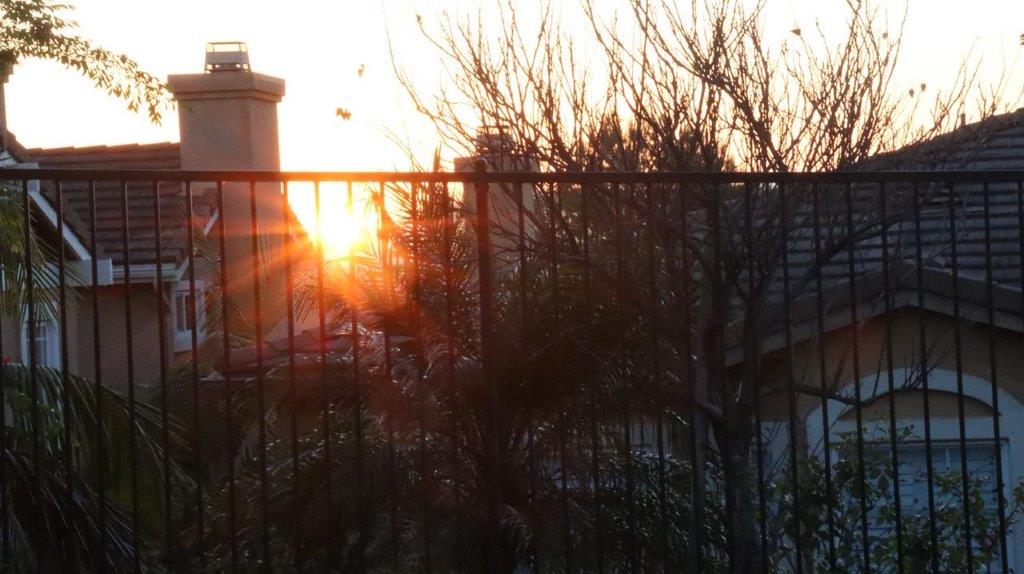 A fence with a sunset behind it

Description automatically generated