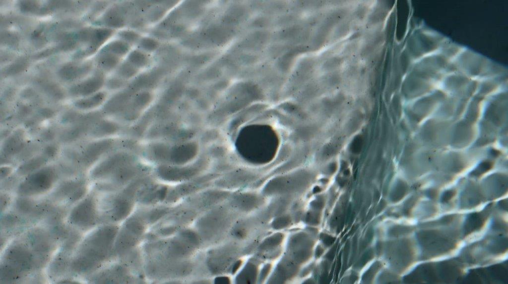 A black hole in the water

Description automatically generated