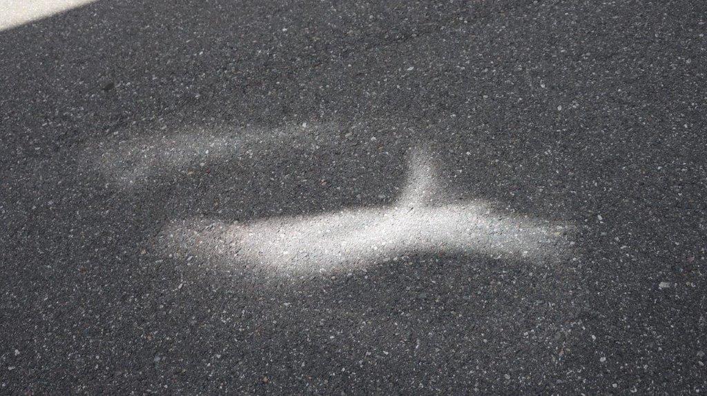 A white line in the middle of a road

Description automatically generated
