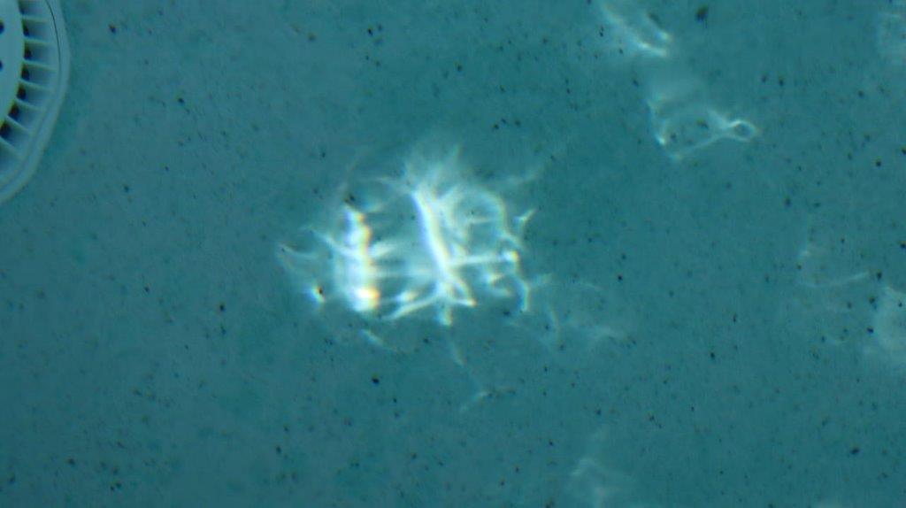 A light reflecting off of a blue surface

Description automatically generated