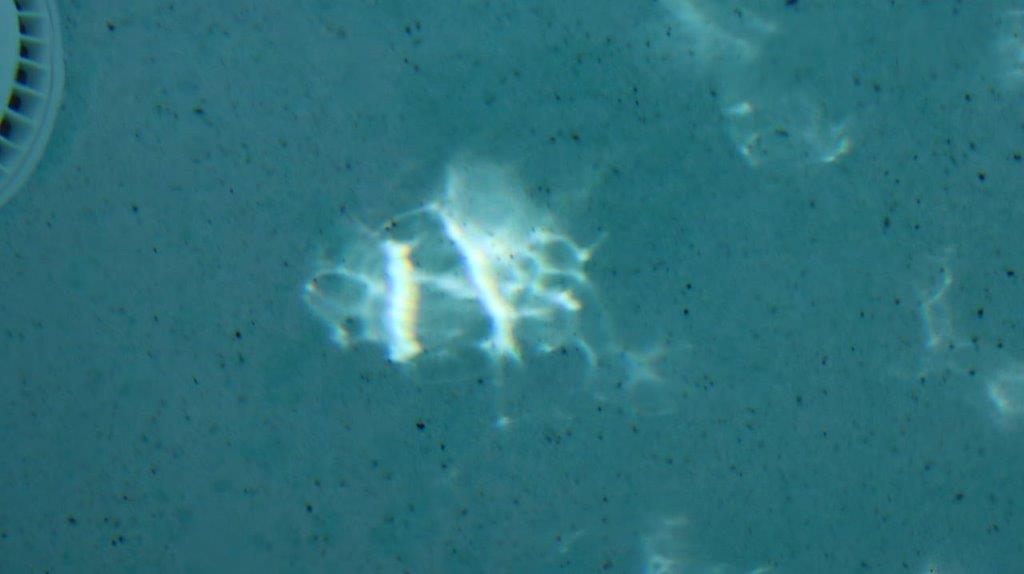 A light reflecting on the surface of water

Description automatically generated