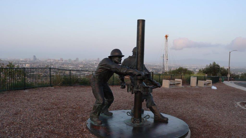A statue of a person holding a pipe

Description automatically generated
