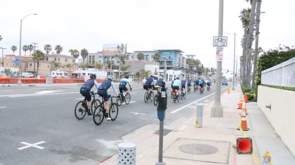 A group of people riding bicycles on a street

Description automatically generated