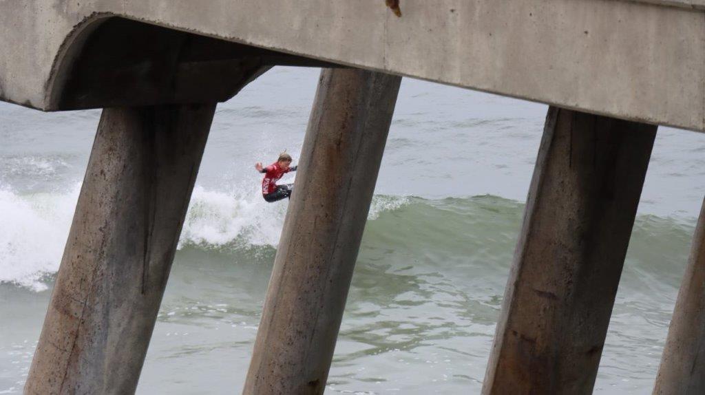 A person jumping from a pier

Description automatically generated