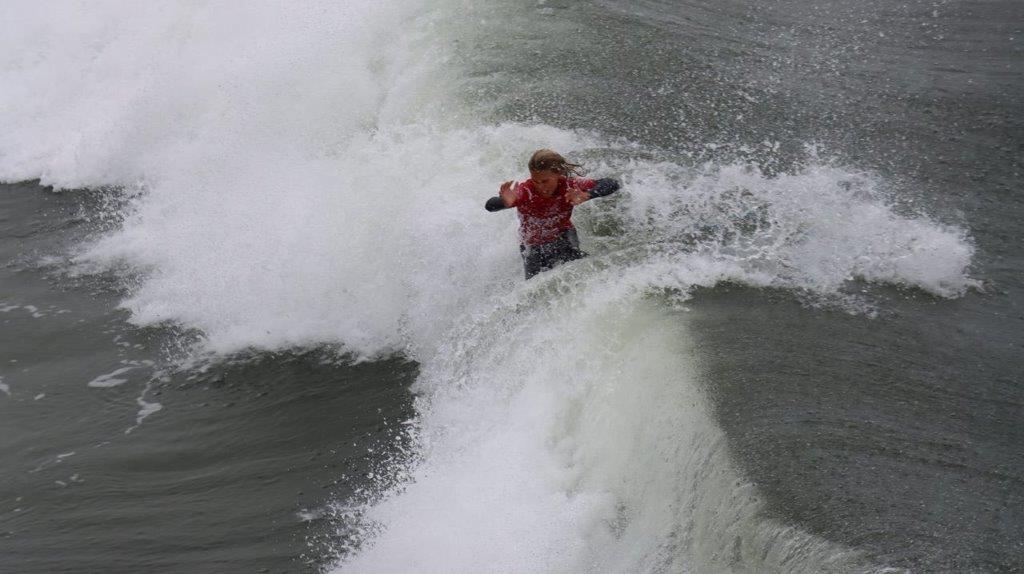 A person surfing on a wave

Description automatically generated