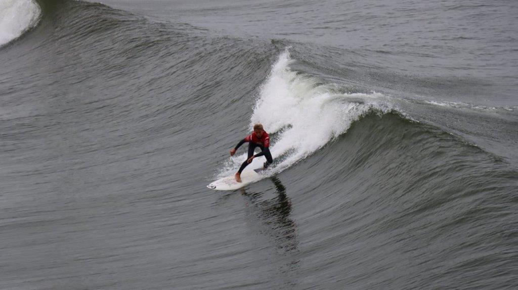 A person surfing on a wave

Description automatically generated
