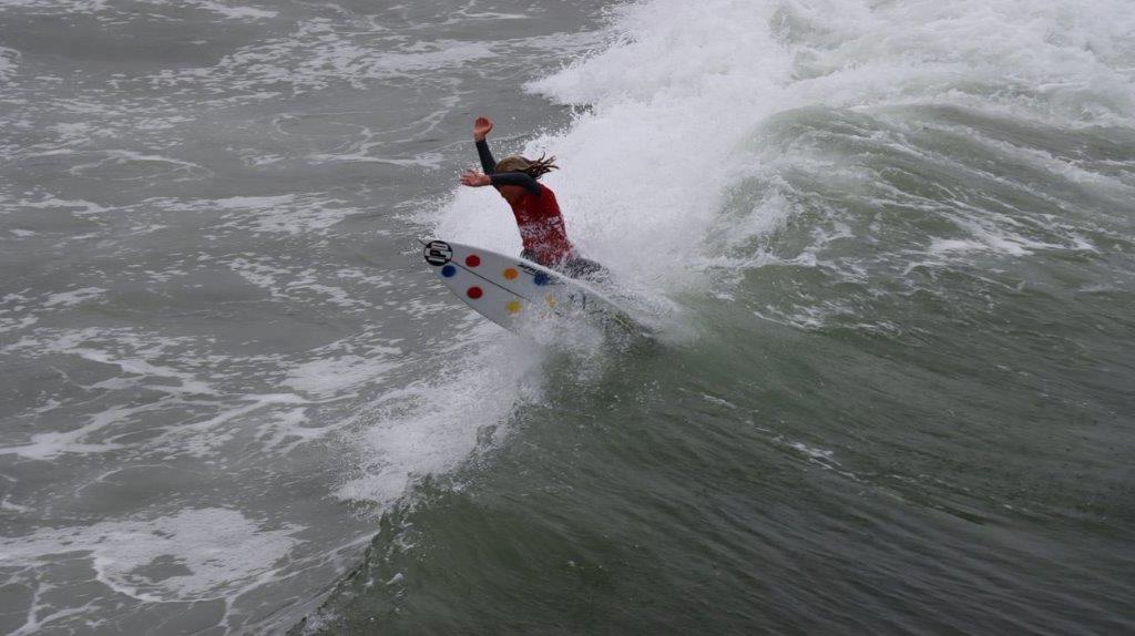 A person surfing on a wave

Description automatically generated