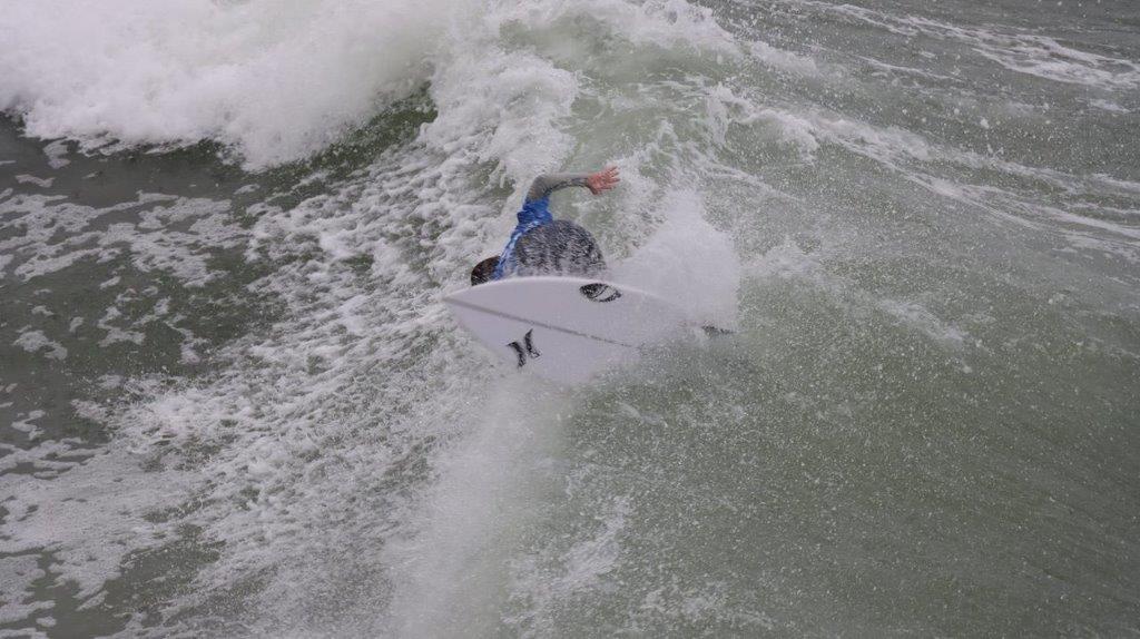 A person surfing in the ocean

Description automatically generated