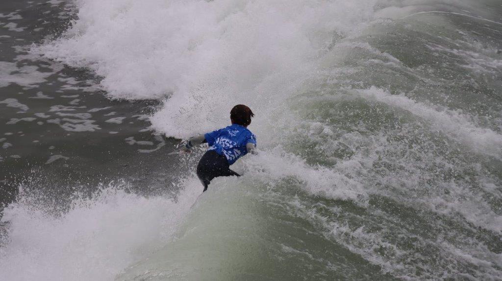 A person surfing on a wave

Description automatically generated