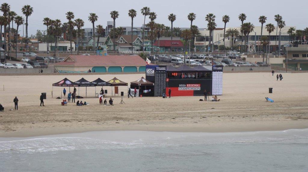 A beach with a building and tents

Description automatically generated with medium confidence