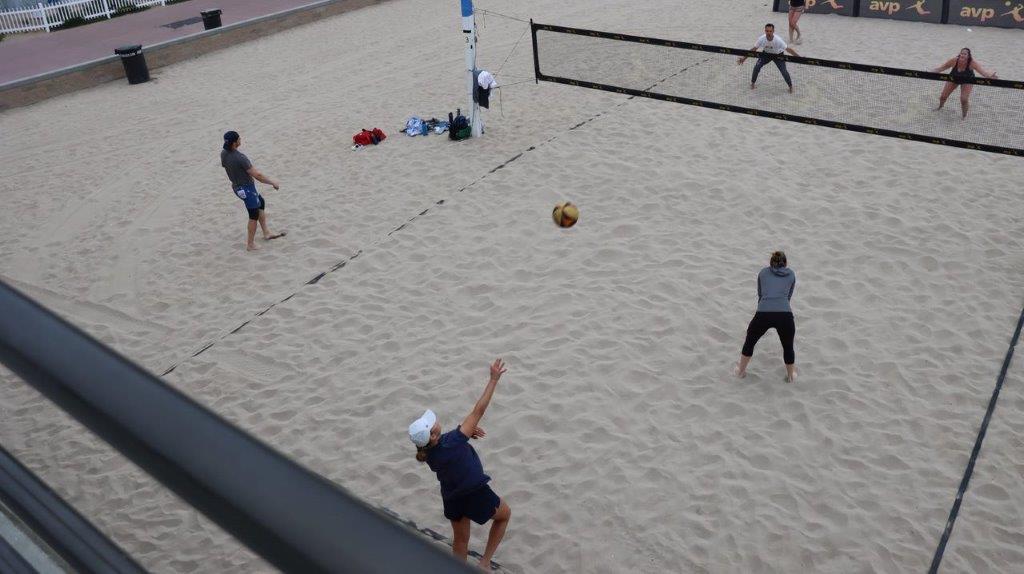 A group of people playing volleyball

Description automatically generated