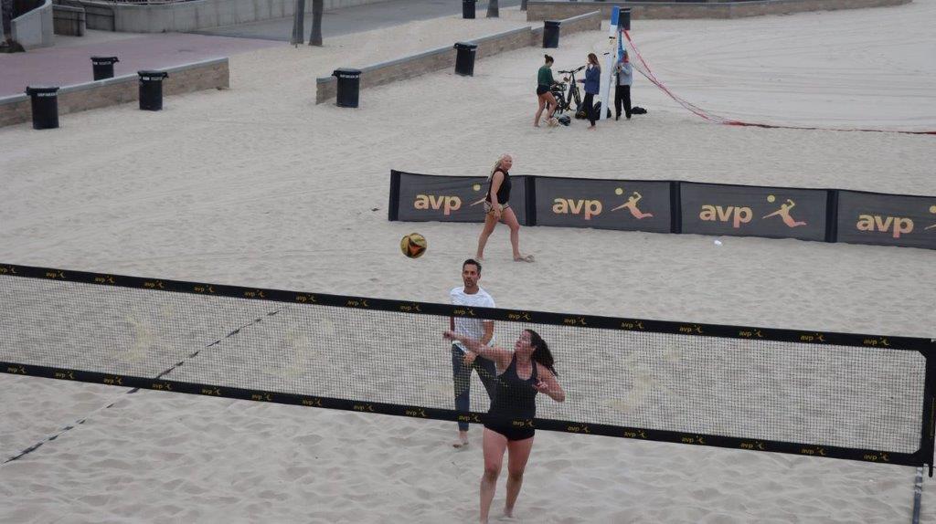 A group of people playing volleyball

Description automatically generated