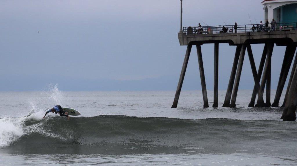 A surfer riding a wave in the ocean

Description automatically generated