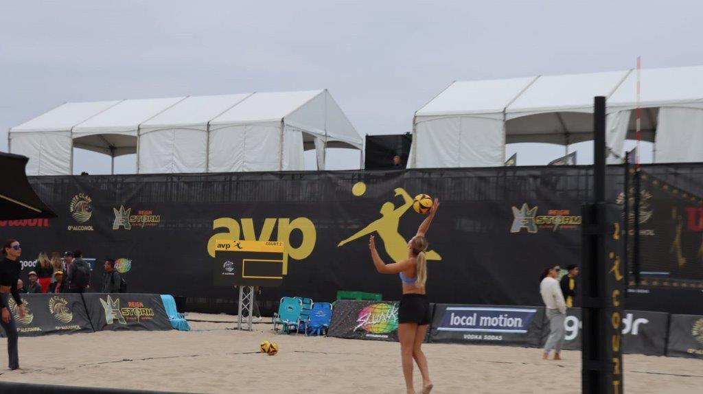 A person playing volleyball on a beach

Description automatically generated