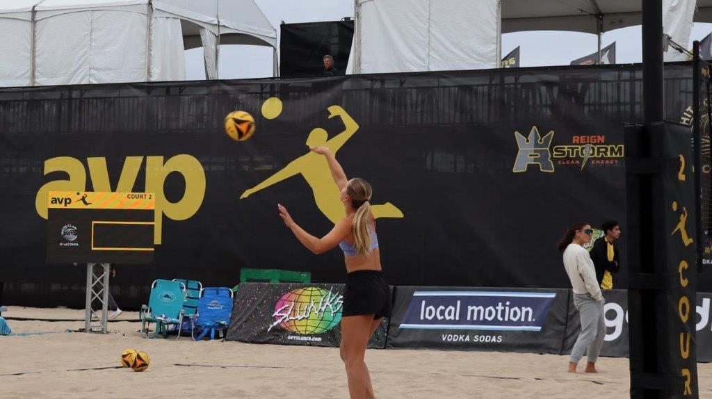 A person playing volleyball on a beach

Description automatically generated