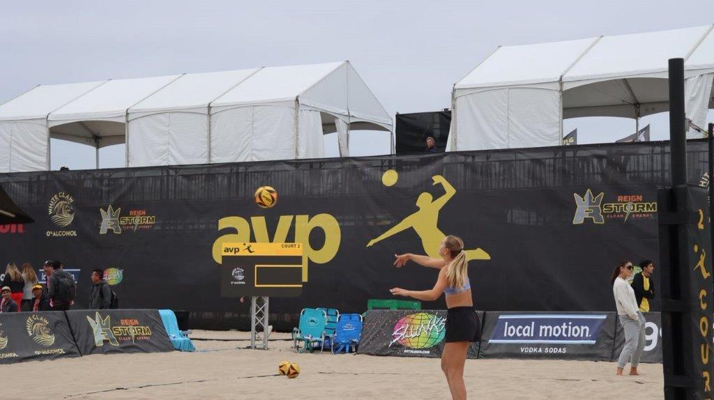 A person playing volleyball on a beach

Description automatically generated