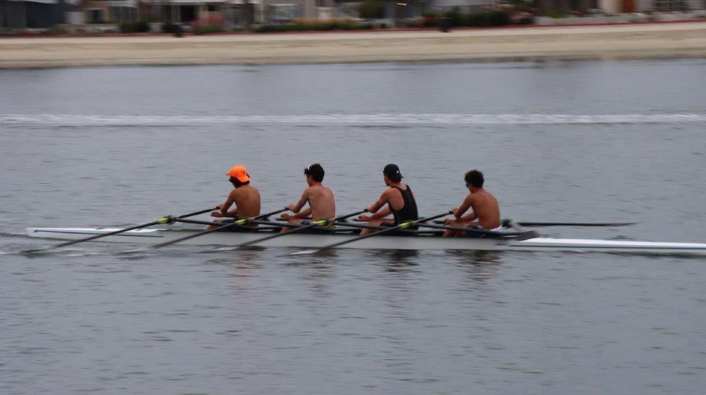 A group of men rowing on a river

Description automatically generated