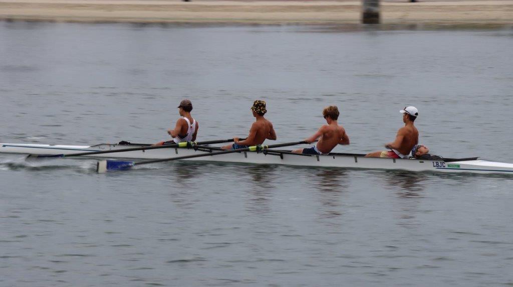 A group of men rowing on a river

Description automatically generated