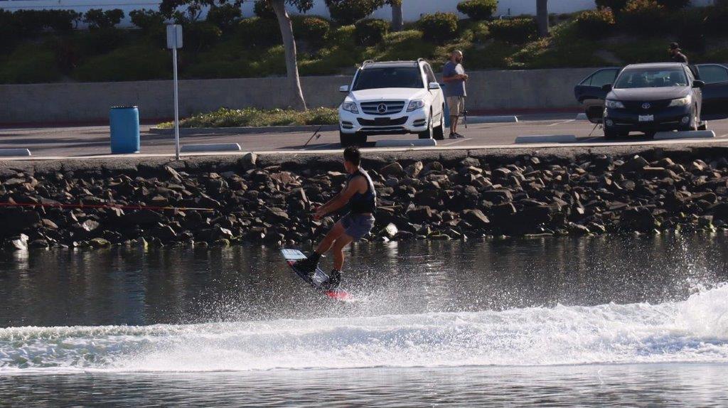A person on a surfboard in the water

Description automatically generated