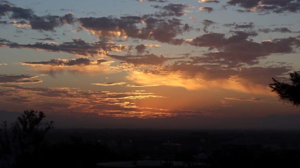 A sunset with clouds in the sky

Description automatically generated